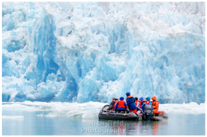 Expedition craft dwarfed by South Sawyer Glacier in Tracy Arm - Ford Terror Wilderness, Alaska.