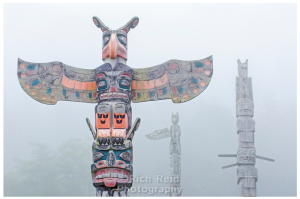 Namgis Burial totem poles in the fog at Alert Bay in British Columbia, Canada.